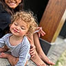 Zoelle joined the competition — help win amazing prizes! child, toddler, smile, curly_hair, sitting, barefoot, outdoor, porch, family, happy, person, casual_clothing, candid, young_child, playful, blurred_background, natural_light, skin, two_children, feet