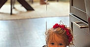 Zoelle joined the competition — help win amazing prizes! toddler, child, balloon, red_headband, crawling, wooden_floor, indoor, curly_hair, white_balloon, furniture, cabinet, string, headband, flooring, person, young_child, cute, home, playful, exploration