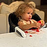 Zoelle joined the competition — help win amazing prizes! toddler, child, curly_hair, watermelon, high_chair, table, food, messy, juice, indoor, person, face, blue_eyes, skin, expression, clothing, seat, focus, home, mealtime