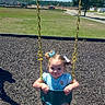 toddler, child, swing, playground, outdoor, sunny, grass, blue_sky, chains, smiling, pigtails, shoes, summer, daytime, park, happy, young_girl, play, casual_clothing, recreation