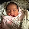 Jaelani is registered to the contest to win money with this photo: newborn, baby, infant, sleepy, swaddled, pink_blanket, baby_clothing, face, portrait, indoors, bed, bedding, pillow, fuzzy_blanket, minnie_mouse, cartoon, smiling, lying_down, close_up, cozy