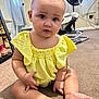 Ariyah joined the competition — help win amazing prizes! baby, child, infant, yellow_clothing, sitting, carpet, indoor, fan, baby_gear, curious, cute, person, floor, legs, feet, hand, face, head, room, window