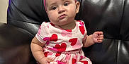 Ariyah is registered to the contest to win money with this photo: baby, casual, child, comfortable, curious_expression, cute, dress, furniture, headband, heart_pattern, indoor, infant, leather_couch, pink_bow, portrait, sitting, small_hands, soft_lighting, white_tights, young_child