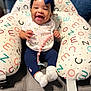 baby, babylaughing, clothing, costume, couch, cushion, face, furniture, happy, hat, head, homedecor, hosiery, laughing, pants, people, person, photography, portrait, sock