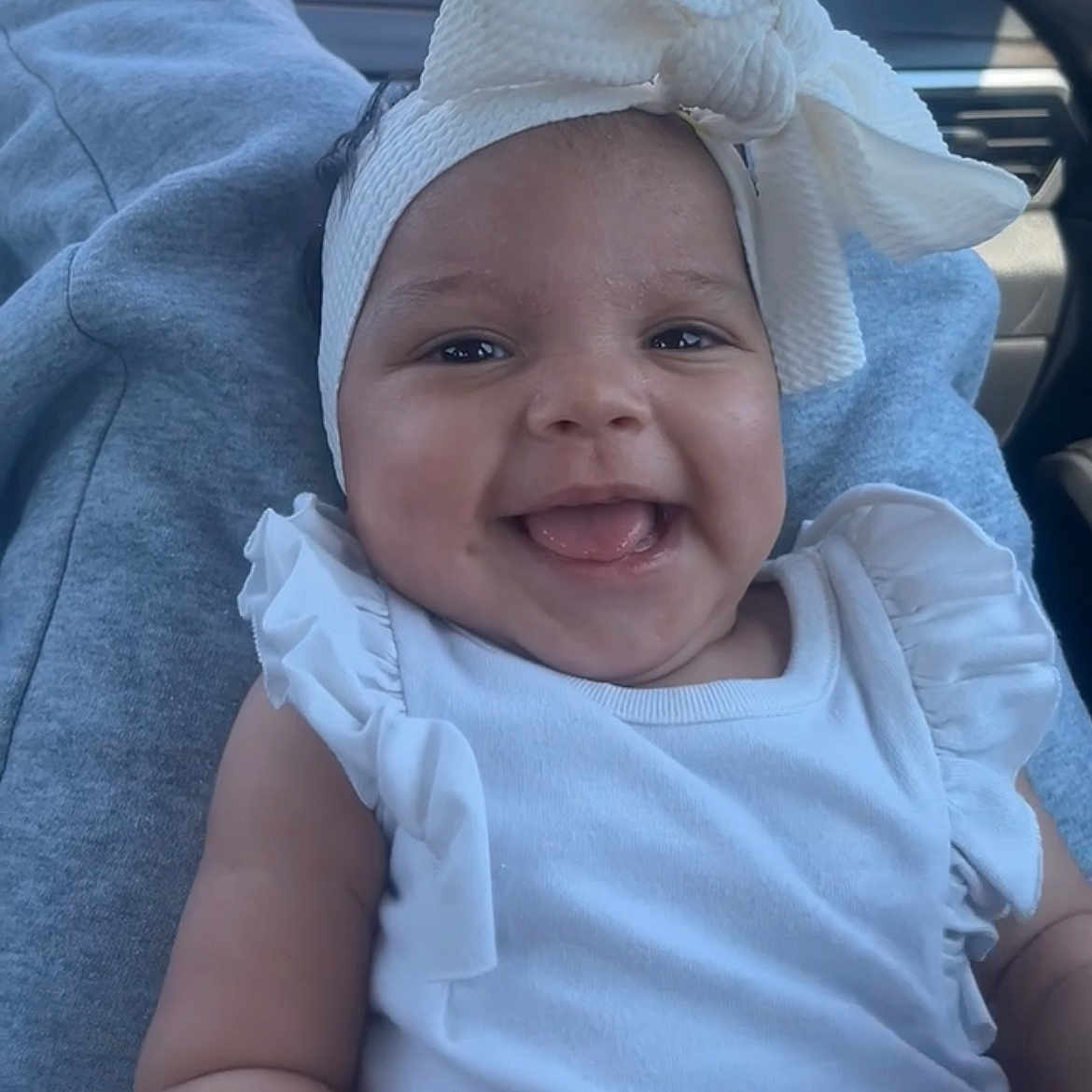 Evonn joined the competition — help win amazing prizes! baby, car_interior, casual, child, closeup, cute, fun, happy, headband, human, infant, joy, person, portrait, ribbon, seat, sitting, smiling, white_clothing, young_child