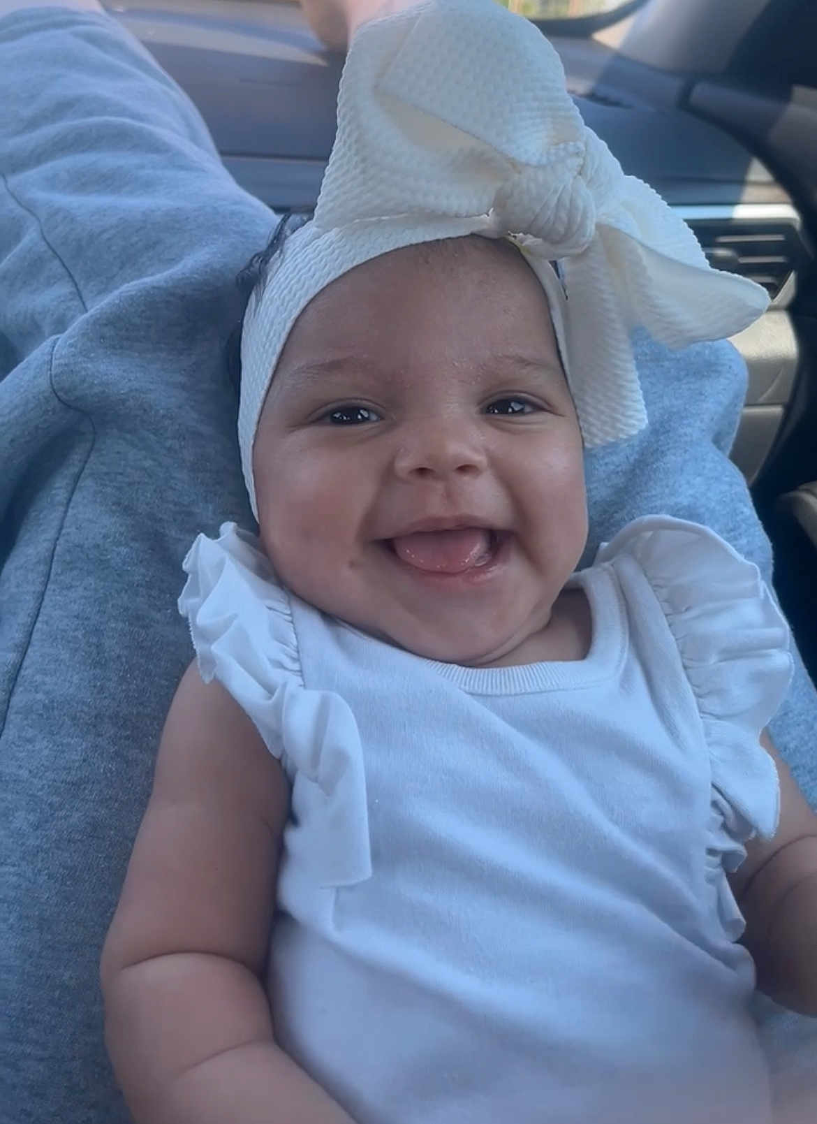 Evonn joined the competition — help win amazing prizes! baby, smiling, headband, white_clothing, car_interior, child, cute, infant, happy, portrait, sitting, closeup, ribbon, young_child, person, human, seat, casual, joy, fun