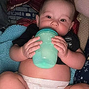 Dustin joined the competition — help win amazing prizes! baby, infant, diaper, bottle, cup, hand, face, skin, clothing, blanket, comfort, lying_down, cute, child, indoor, young, person, holding, expression, relax