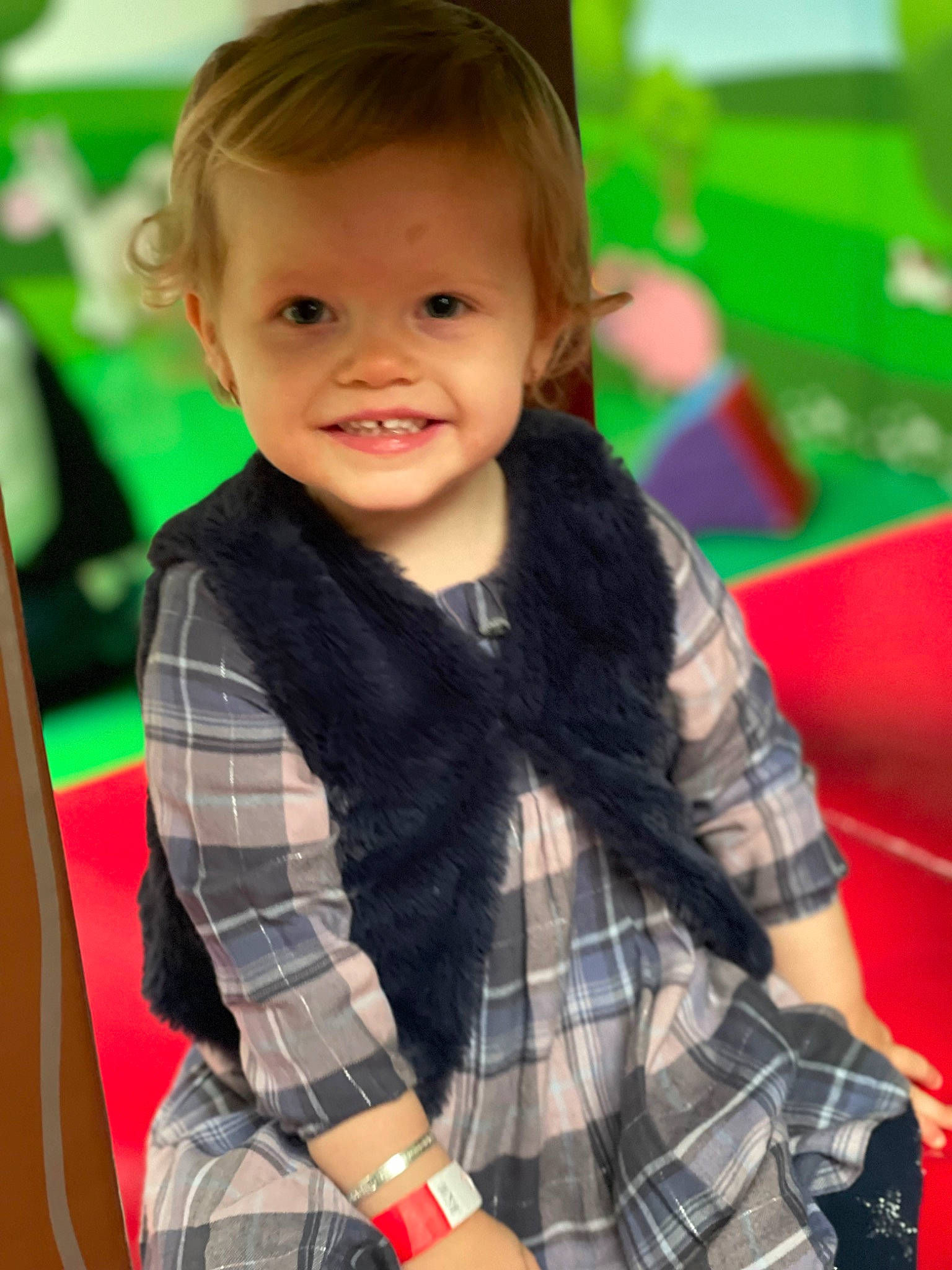 Evie-mae is registered to the contest to win money with this photo: brown_hair, cheek, child, city, fun, happy, joy, leisure, pattern, person, plaid, play, recreation, room, sitting, skin, sleeve, smile, tartan, textile