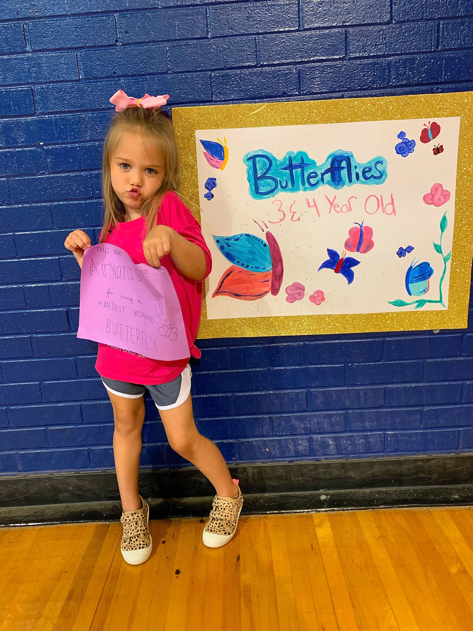 Aryanna joined the competition — help win amazing prizes! electric_blue, event, floor, flooring, footwear, fun, happy, hardwood, human_leg, knee, leisure, magenta, pattern, person, purple, shoe, sock, sportswear, thigh, toddler