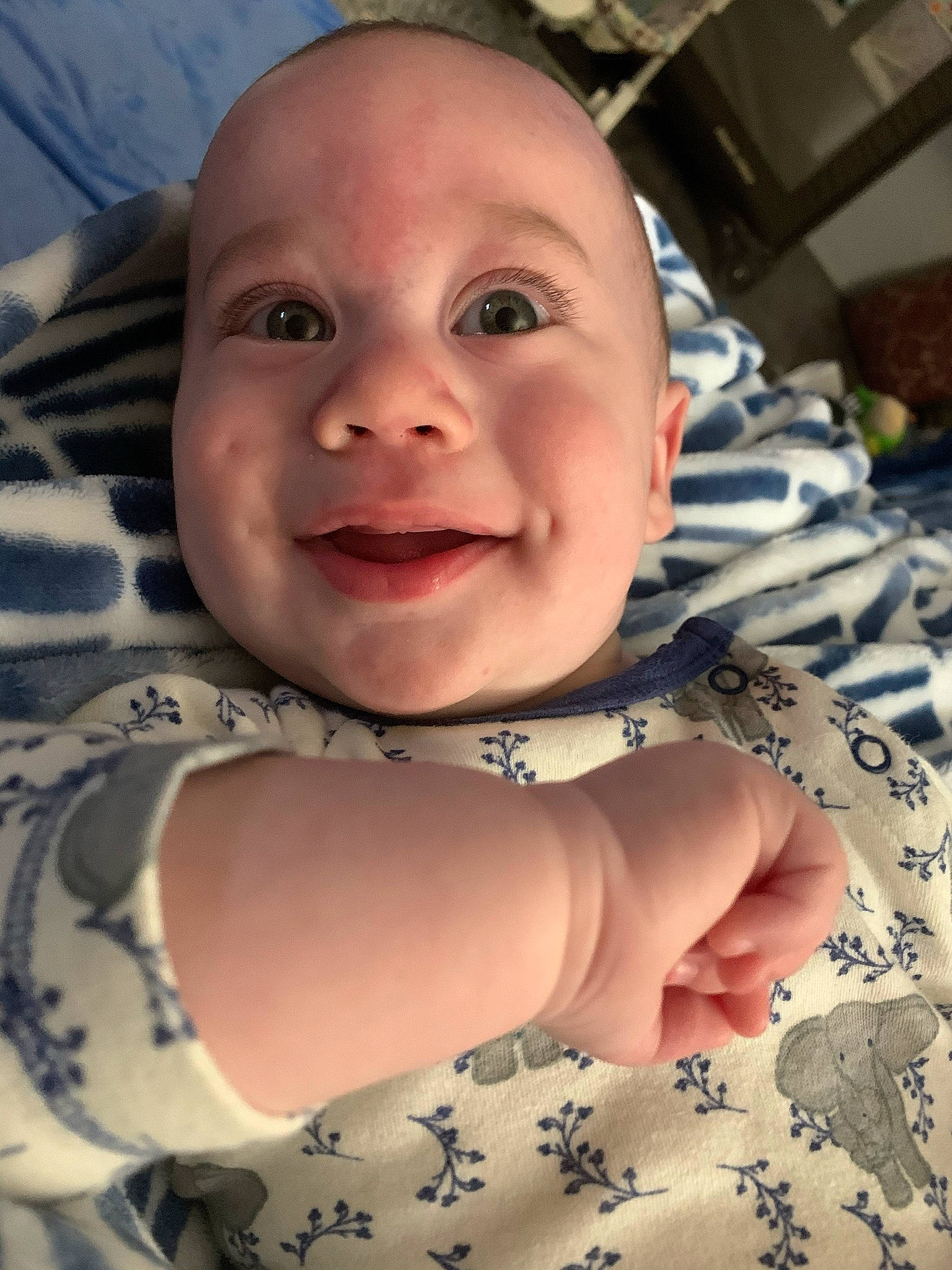 Ezra is registered to the contest to win money with this photo: baby, baby_laughing, baby_toddler_clothing, cheek, chest, child, chin, eye, eyebrow, face, gesture, happy, iris, joy, lip, mouth, nose, person, skin, sleeve