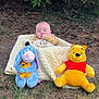 Saint is registered to the contest to win money with this photo: baby, child, blanket, plush_toy, winnie_the_pooh, eeyore, outdoor, grass, tree, greenery, cute, infant, toy, nature, soft_toy, sitting, wrapped, childhood, playful, smiling