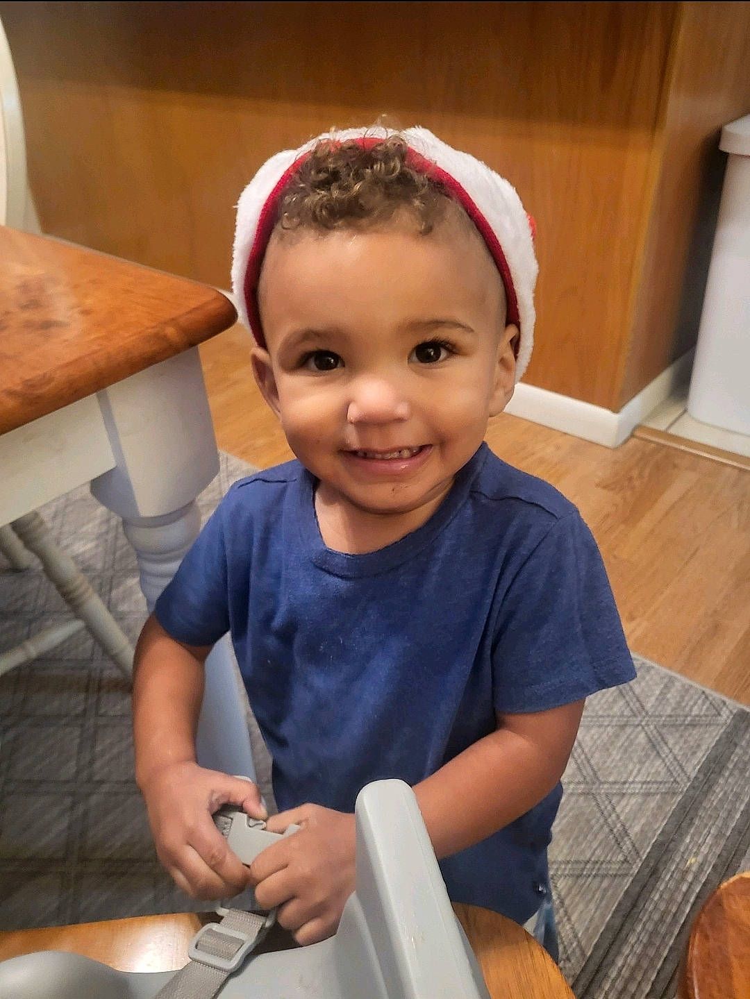 Drew is registered to the contest to win money with this photo: baby, baby_toddler_clothing, cap, chair, cheek, child, comfort, fun, happy, hardwood, headband, joy, lap, person, room, sitting, skin, smile, t_shirt, toddler