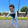 Kingston is registered to the contest to win money with this photo: baby, child, swing, playground, outdoor, sunny, blue_sky, grass, residential, pajamas, curly_hair, happy, play, person, daytime, bench, car, safety, fun, park