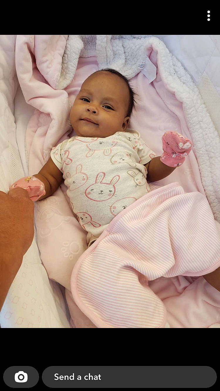 Cienna is registered to the contest to win money with this photo: baby, baby_toddler_clothing, cheek, chin, comfort, eye, face, finger, happy, head, headgear, human_body, iris, lip, person, pink, skin, sleeve, smile, stomach