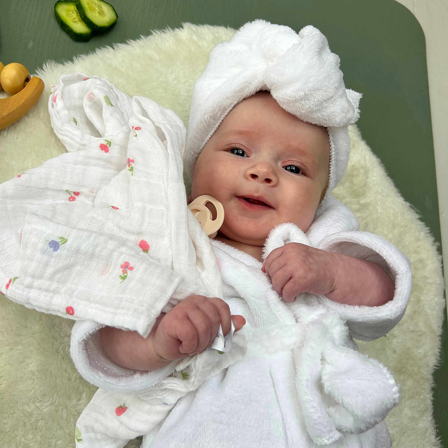 Marliah is registered to the contest to win money with this photo: baby, blanket, comfort, cozy, cucumber_slices, cute, face, hand, headwear, indoors, infant, lying_down, pacifier, person, portrait, skin, smiling, soft_texture, towel_turban, white_robe