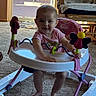 baby, infant, baby_walker, pink_clothing, smiling, indoor, carpet, rocking_chair, blanket, toy, window, door, daylight, furniture, foot, person, child, happy, play, living_room