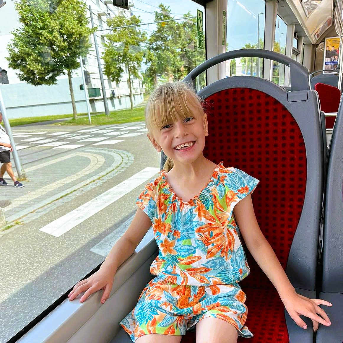 Lyloo participe au concours pour gagner de l'argent avec cette photo : beachwear, blouse, child, city, clothing, dress, face, female, girl, head, outdoors, person, photography, portrait, road, shorts, sitting, sleeve, street, urban