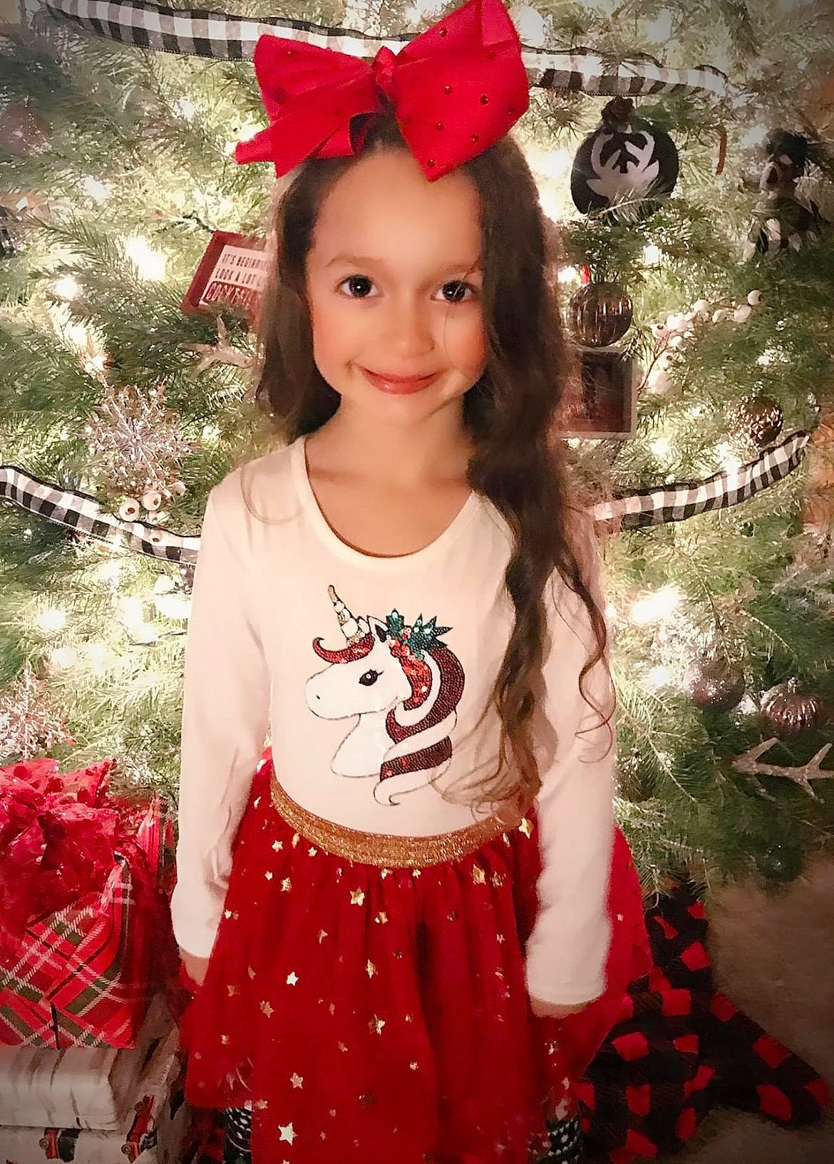 Mackenzie is registered to the contest to win money with this photo: baby_toddler_clothing, christmas_ornament, clothing, eye, facial_expression, hair, hairstyle, happy, human_body, joy, leaf, neck, organ, outerwear, person, pink, red, sleeve, smile, standing