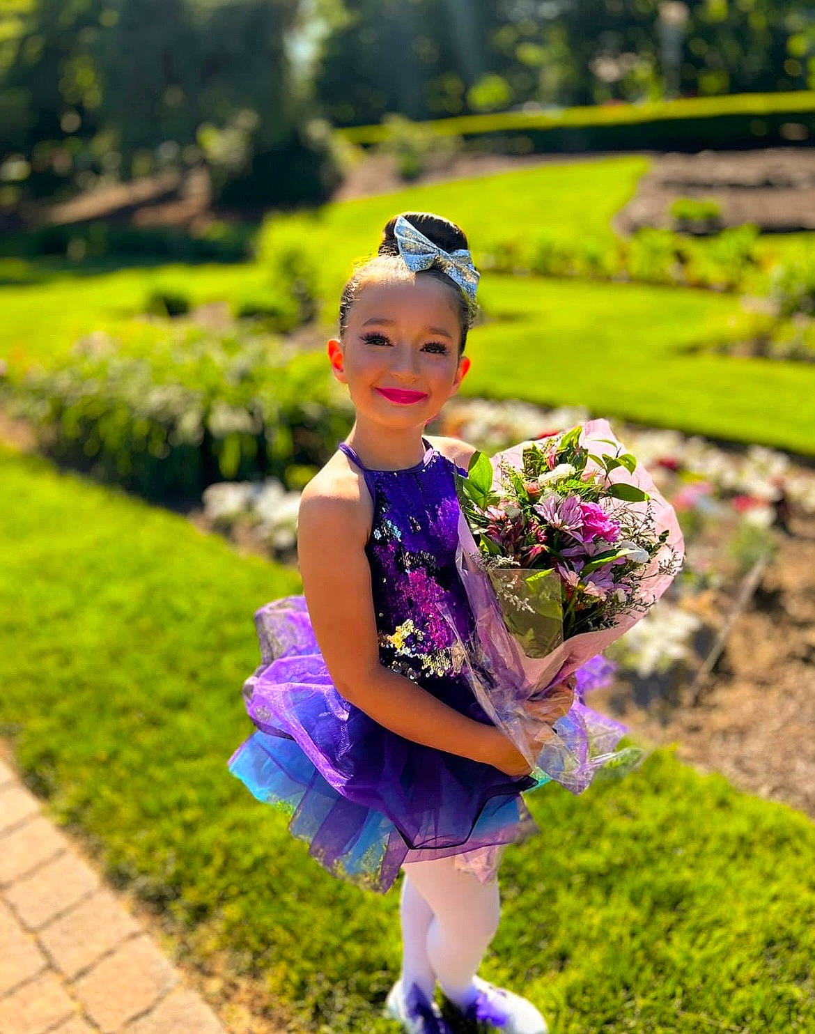 Mackenzie is registered to the contest to win money with this photo: beauty, dress, electric_blue, flash_photography, flower, grass, grassland, happy, joy, leisure, magenta, meadow, nature, people_in_nature, person, pink, plant, purple, smile, summer