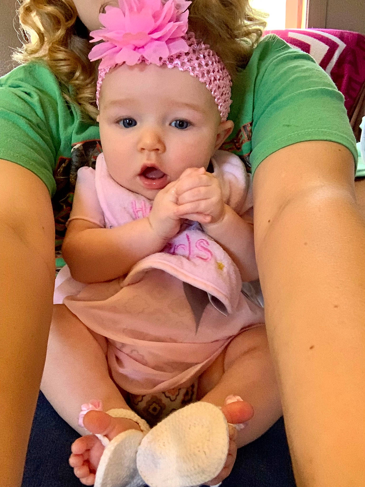 Jessie is registered to the contest to win money with this photo: abdomen, baby, baby_toddler_clothing, cap, child, facial_expression, finger, fun, happy, hat, headband, headgear, headwear, human_body, organ, person, pink, sitting, skin, surprise