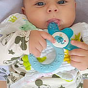 Sebastian Milan participe au concours pour gagner de l'argent avec cette photo : baby, infant, teething_toy, blue_eyes, mickey_mouse_print, clothing, hand, face, person, closeup, cute, child, sitting, comfort, soft_toys, parent, white_tank_top, playful, indoor, portrait