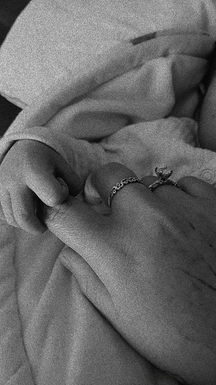 Ale is registered to the contest to win money with this photo: baby_hand, adult_hand, ring, blanket, black_and_white, close_up, skin, touch, connection, love, bond, soft, newborn, family, intimacy, fingers, wrapping, comfort, gentle, care