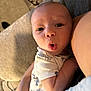 J.j. joined the competition — help win amazing prizes! baby, infant, face, expression, surprised, person, arm, clothing, onesie, indoor, couch, blanket, skin, head, eyes, mouth, hand, closeup, human, babywear