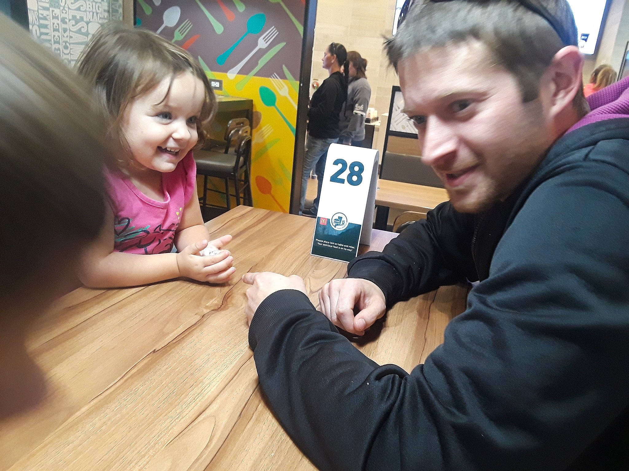 Kira joined the competition — help win amazing prizes! arm, chair, event, fun, gesture, hair, hairstyle, hand, hardwood, head, joy, leisure, person, recreation, sharing, smile, table, tableware, thumb, varnish