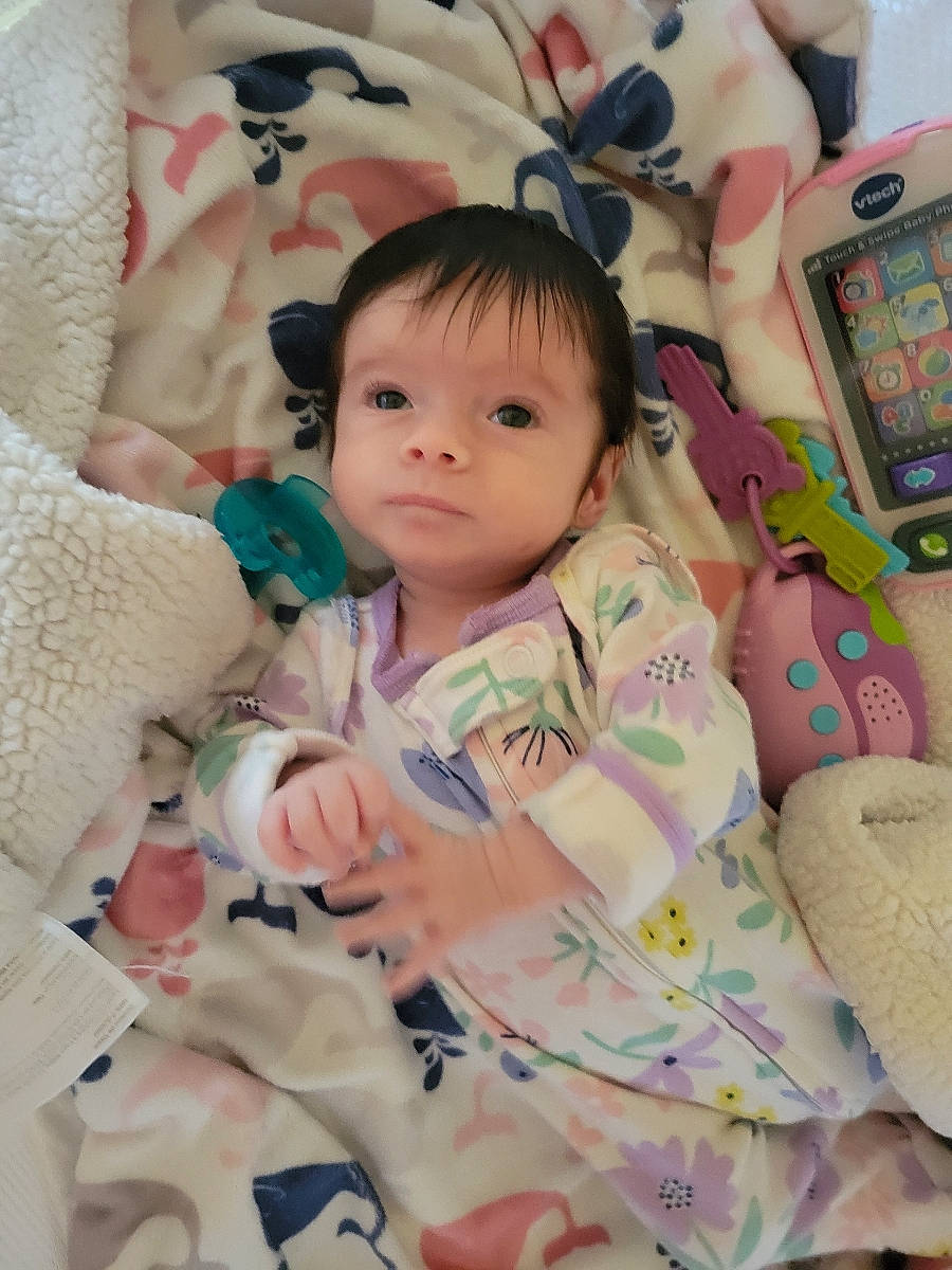 Rylin joined the competition — help win amazing prizes! baby, baby_products, baby_toddler_clothing, bed_sheet, bedding, bedtime, cheek, child, comfort, face, happy, linens, pattern, person, pink, product, room, skin, stuffed_toy, textile