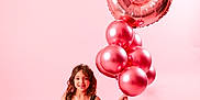 Saisha is registered to the contest to win money with this photo: child, girl, birthday, balloons, number_6, pink_background, tutu_dress, black_dress, crown, helium_balloons, metallic_balloon, studio_portrait, smiling, sitting, party, celebration, pink_theme, ribbon, shoe, long_hair