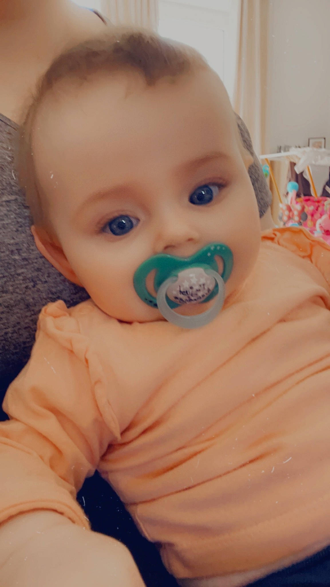 Casey is registered to the contest to win money with this photo: baby, baby_toddler_clothing, cheek, child, comfort, ear, eyebrow, eyelash, finger, flooring, fun, happy, iris, lip, nose, person, sitting, skin, sleeve, thumb