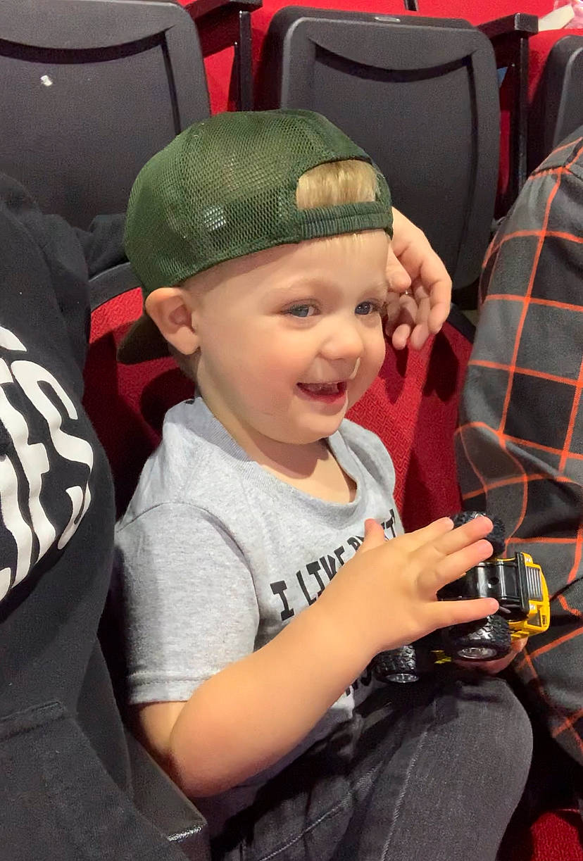 Maxon is registered to the contest to win money with this photo: auto_part, automotive_design, automotive_tire, baby, baby_carriage, cap, car_seat, child, fun, headwear, helmet, joy, motor_vehicle, person, personal_protective_equipment, sitting, smile, snapshot, t_shirt, tartan