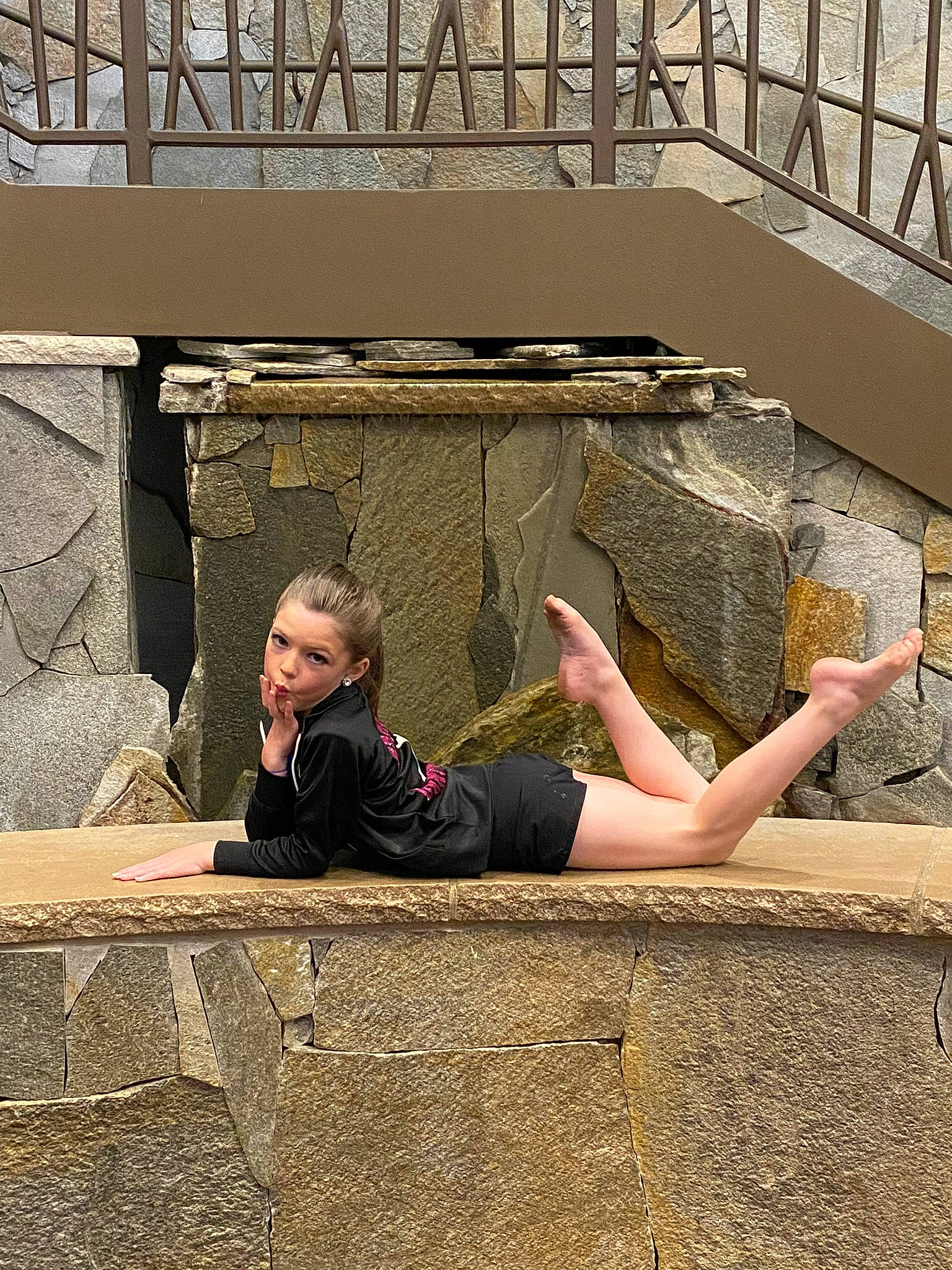 Tenley is registered to the contest to win money with this photo: comfort, eyewear, flooring, foot, fun, grass, hairstyle, human_leg, knee, leisure, person, road_surface, shadow, sidewalk, sitting, street, thigh, toddler, tourism, vacation