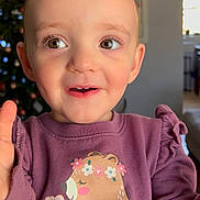 Emma Ruth joined the competition — help win amazing prizes! toddler, child, smiling, purple_sweatshirt, bear_graphic, flower, indoor, christmas_tree, holiday_decor, face, eyes, expression, cute, happy, portrait, young_child, sitting, home, cozy, long_sleeves