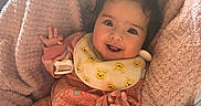 Olivia joined the competition — help win amazing prizes! baby, child, smile, happy, cozy, blanket, onesie, infant, cute, face, portrait, hand, pink, orange, warm, soft, indoors, person, newborn, clothing