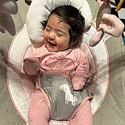 Olivia joined the competition — help win amazing prizes! baby, smiling, pink_onesie, face, infant, child, seat, cushion, toy, hanging_toy, happy, indoor, floor, checkered_floor, hair, person, cute, cozy, laughing, baby_seat