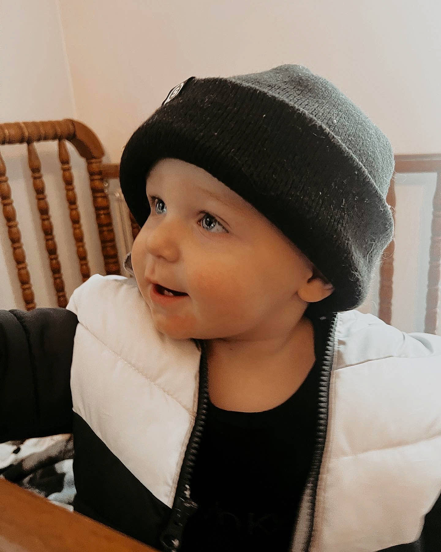 Elijah is registered to the contest to win money with this photo: baby, baby_toddler_clothing, cap, chair, cheek, chin, comfort, eye, eyebrow, fashion_accessory, happy, head, headgear, headwear, knit_cap, lip, neck, outerwear, person, sleeve