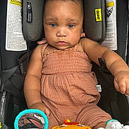 Autumn is registered to the contest to win money with this photo: baby, child, car_seat, toy, mirror, orange, white, clothing, infant, seatbelt, safety, cute, serious, indoors, person, playtime, childrens_toy, closeup, colorful, young
