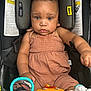 baby, child, car_seat, toy, mirror, orange, white, clothing, infant, seatbelt, safety, cute, serious, indoors, person, playtime, childrens_toy, closeup, colorful, young