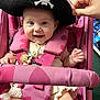 baby, pirate_hat, pink, stroller, child, smiling, happy, cute, infant, seatbelt, hand, toy, clothing, face, portrait, indoor, playful, accessory, heart_pattern, childcare
