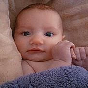 Koralisa is registered to the contest to win money with this photo: baby, blanket, face, infant, skin, hand, expression, blue_eyes, closeup, portrait, soft_texture, cozy, comfort, child, newborn, cute, warm, toddler, lying_down, indoors