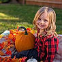 Hope is registered to the contest to win money with this photo: child, smiling, blonde_hair, red_shirt, checkered_shirt, pumpkin, autumn_leaves, blanket, outdoor, fall, nature, grass, portrait, cute, happy, seasonal, holiday, festive, young_child, sunlight