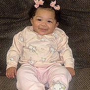 Miyori joined the competition — help win amazing prizes! baby, child, girl, smile, pink_bows, curly_hair, pajamas, animal_prints, socks, couch, brown_couch, indoors, happy, seated, comfortable, cute, portrait, infant, cozy, home