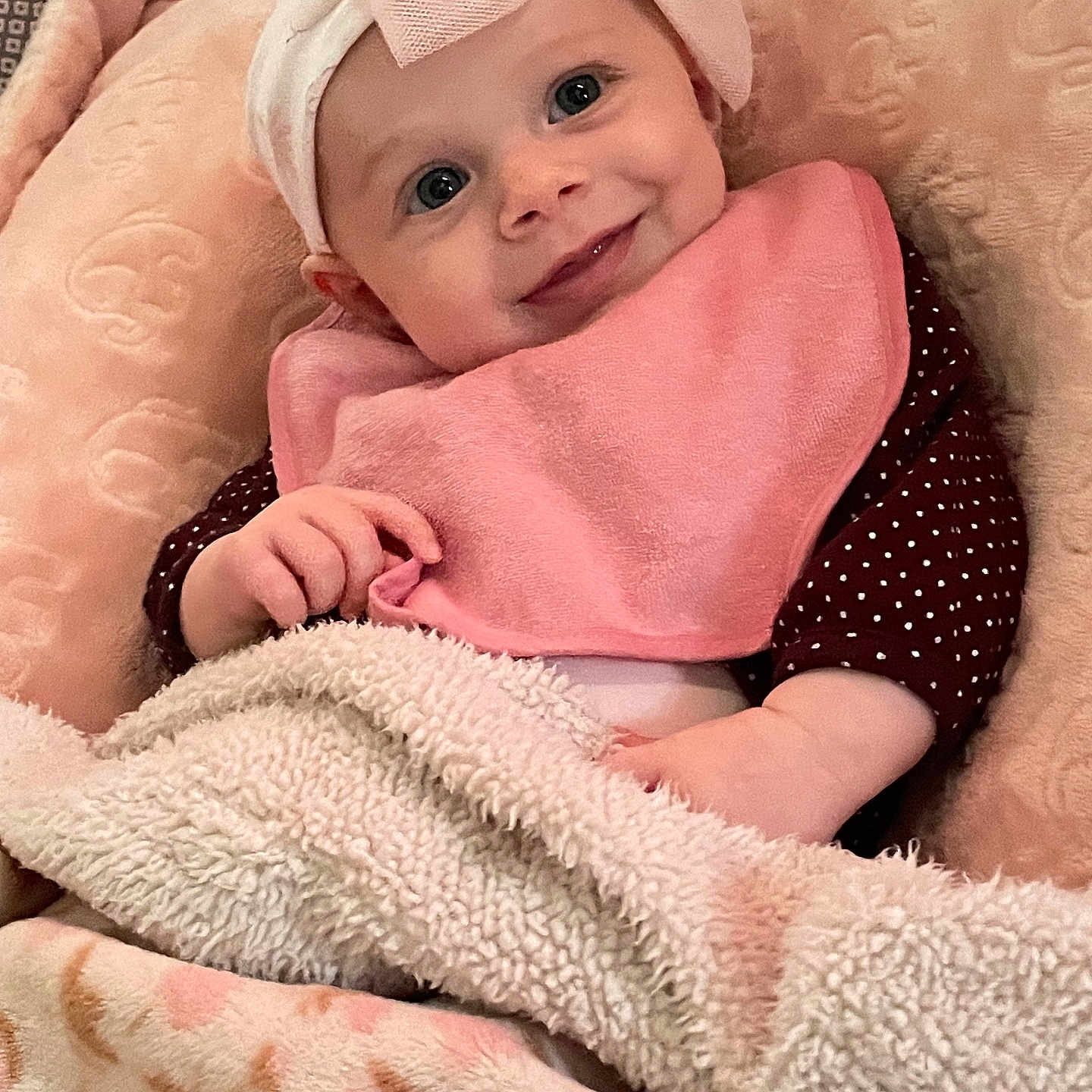 Kameryn Jo is registered to the contest to win money with this photo: baby, baby_bib, blanket, child, clothing, comfort, cozy, cute, face, hand, happy, headband, indoor, infant, pink, portrait, resting, smile, soft, warm