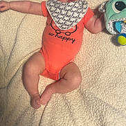 Kameryn Jo joined the competition — help win amazing prizes! baby, bib, blanket, blue_eyes, child, cute, expression, face, foot, hand, headband, indoor, infant, lying_down, onesie, orange_clothing, person, plush_toy, smile, soft_toy
