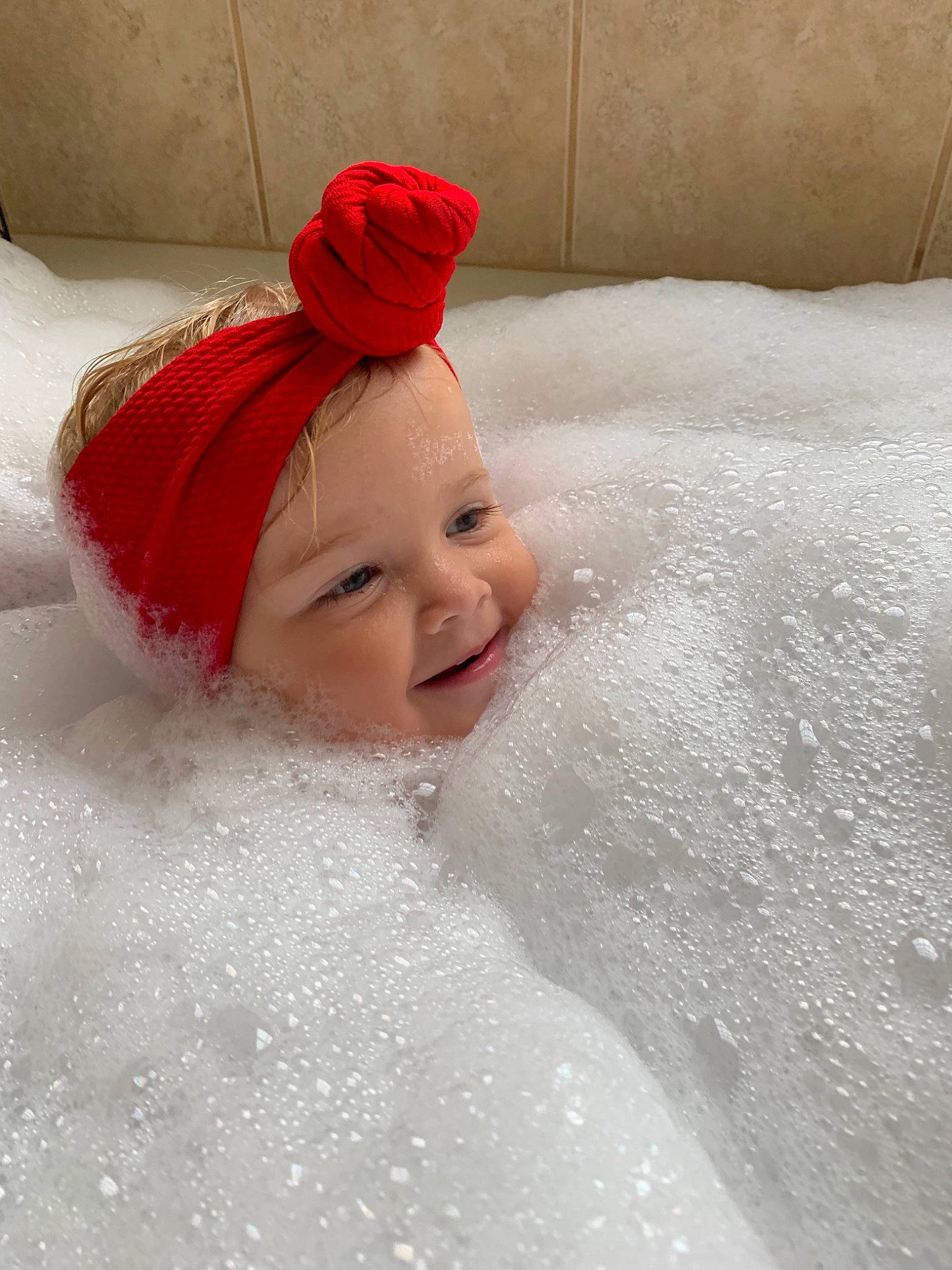Ailie joined the competition — help win amazing prizes! baby, bathing, bathtub, child, foam, fun, headgear, joy, person, playing_in_the_snow, red, smile, toddler