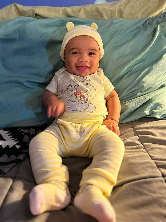 Kauirs joined the competition — help win amazing prizes! baby, baby_toddler_clothing, cap, cheek, child, comfort, eye, face, fun, grass, happy, headwear, joy, lap, linens, person, product, sitting, skin, sleeve