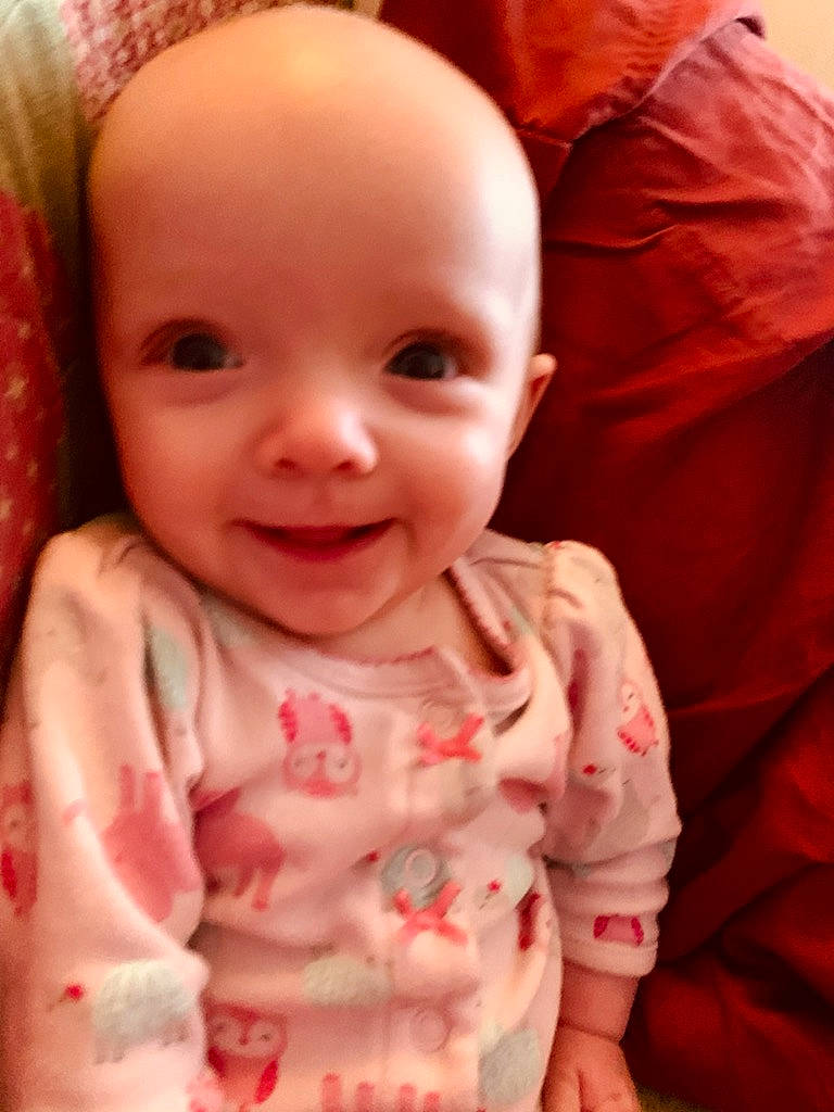 Hadleigh is registered to the contest to win money with this photo: arm, baby_toddler_clothing, cheek, chin, eye, eyebrow, face, forehead, hair, hairstyle, head, human_body, iris, joy, lip, mouth, nose, outerwear, person, skin