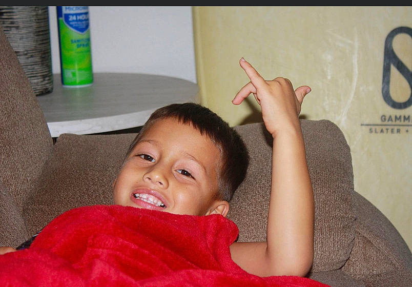 Ikaika is registered to the contest to win money with this photo: arm, cheek, comfort, elbow, finger, flooring, fun, gesture, happy, mouth, nail, neck, person, room, sitting, skin, sleeve, smile, thumb, toddler