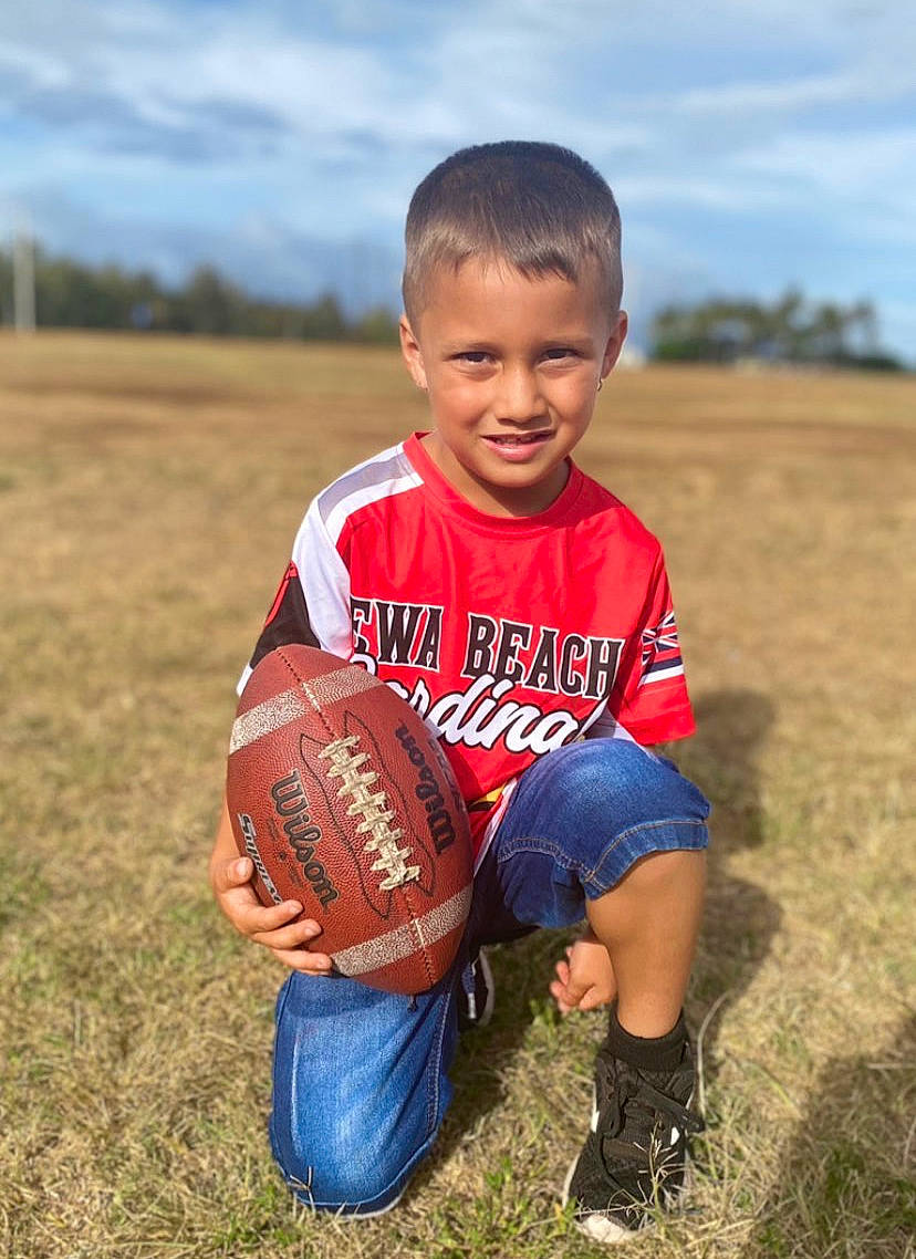 Ikaika joined the competition — help win amazing prizes! american_football, ball, ball_game, baseball_glove, cloud, football, glove, grass, happy, joy, leg, people_in_nature, person, player, shoe, shorts, sky, smile, sneakers, soccer_ball